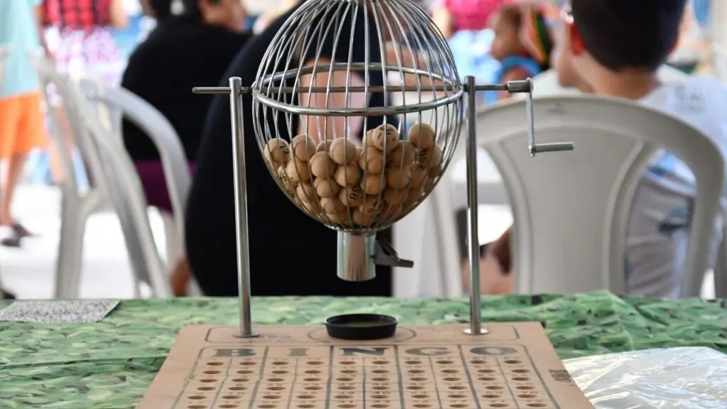 Bingo cage filled with numbered balls on a table