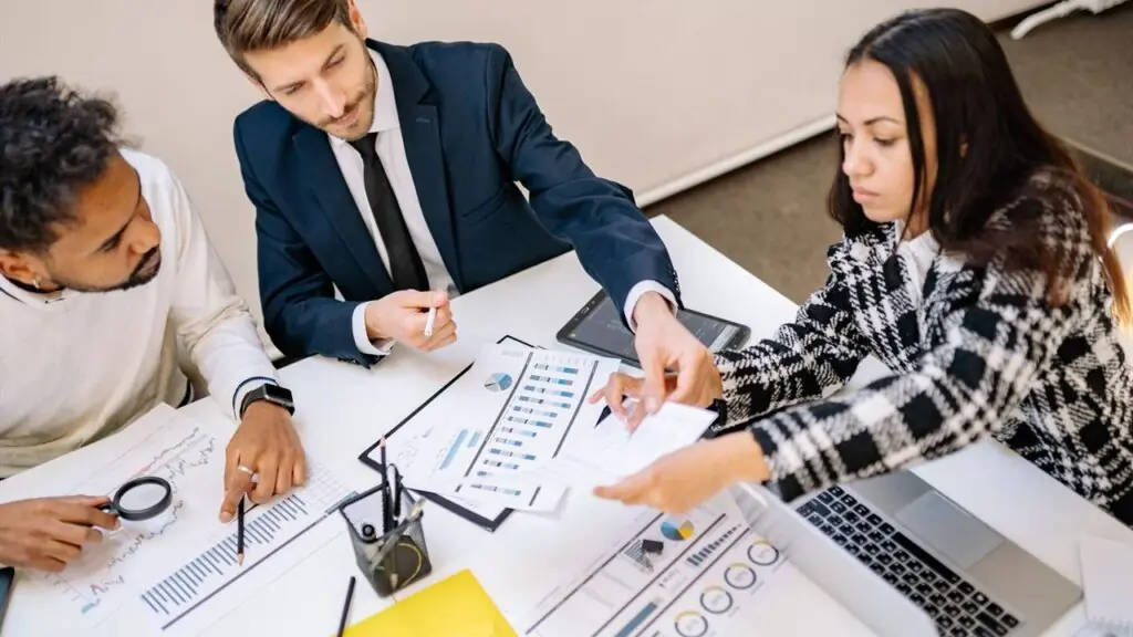 Business colleagues reviewing charts and documents