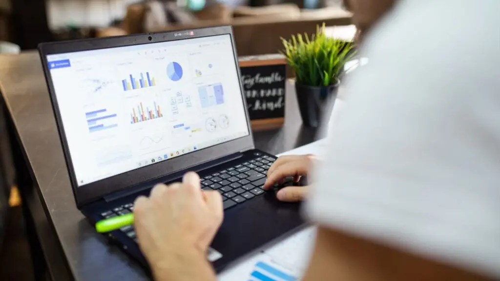 Focused analysis of charts on a laptop