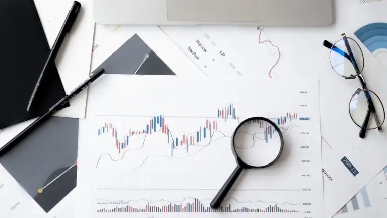 Magnifying glass over charts and research notes