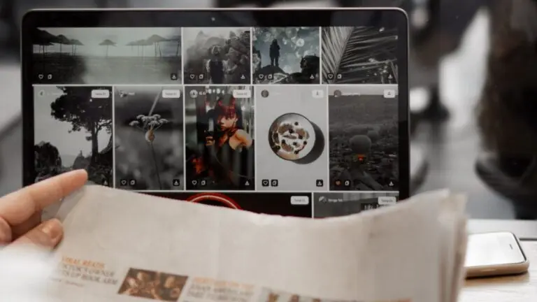 Newspaper beside an open laptop